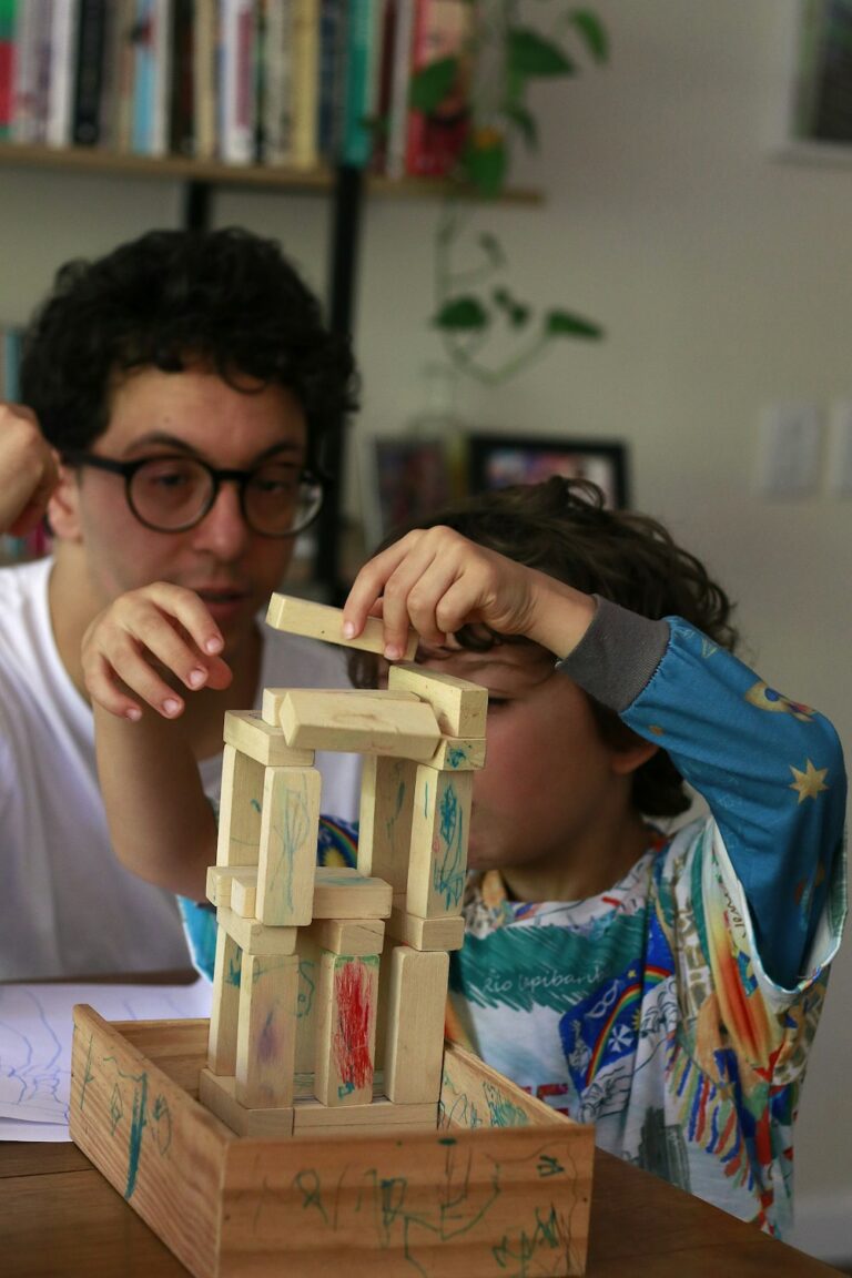 An adult patiently guiding a child through a hands-on activity, illustrating what an ABA session looks like
